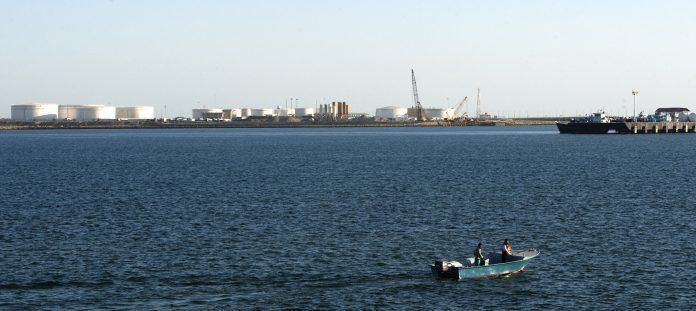 A speed boat passes by oil docks at the port of Kalantari in the city of Chabahar