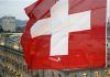 A Swiss National Flag Waves in Front of the Headquarters of Swiss Bank