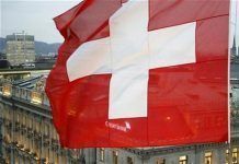 A Swiss National Flag Waves in Front of the Headquarters of Swiss Bank