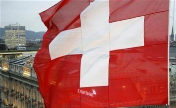 A Swiss National Flag Waves in Front of the Headquarters of Swiss Bank