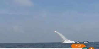 An Iranian cruise missile fires into the air from a submarine during a test at Strait of Hormuz