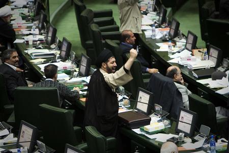FILE PHOTO: A cleric, member of Parliament (MP), shakes his fist as he chants anti-US/UK slogans during a debate in regime's parliament. REUTERS