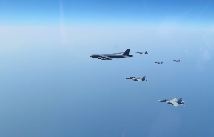 United States aircraft carrier Abraham Lincoln (CVN 72) and a U.S. Air Force B-52H Stratofortress, deployed to the region, conduct joint exercises in Arabian Sea