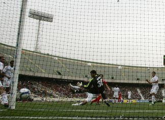 Al-Sharjah's goalkeeper Hassan concedes a goal to Persepolis during AFC Champions League match in Tehran