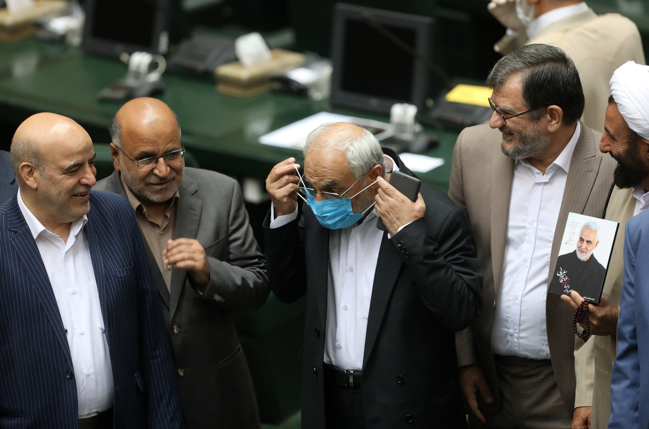 An Iranian lawmaker wears a protective face mask, as he attends the opening ceremony of Iran's 11th parliament, as the spread of the coronavirus disease (COVID-19) continues, in Tehran, Iran, May 27, 2020. 