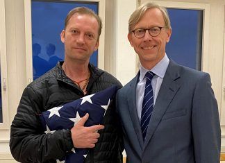 Michael White, a freed U.S. Navy veteran detained in Iran since 2018, poses with U.S. Special Envoy for Iran Brian Hook in Zurich