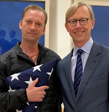 Michael White, a freed U.S. Navy veteran detained in Iran since 2018, poses with U.S. Special Envoy for Iran Brian Hook in Zurich