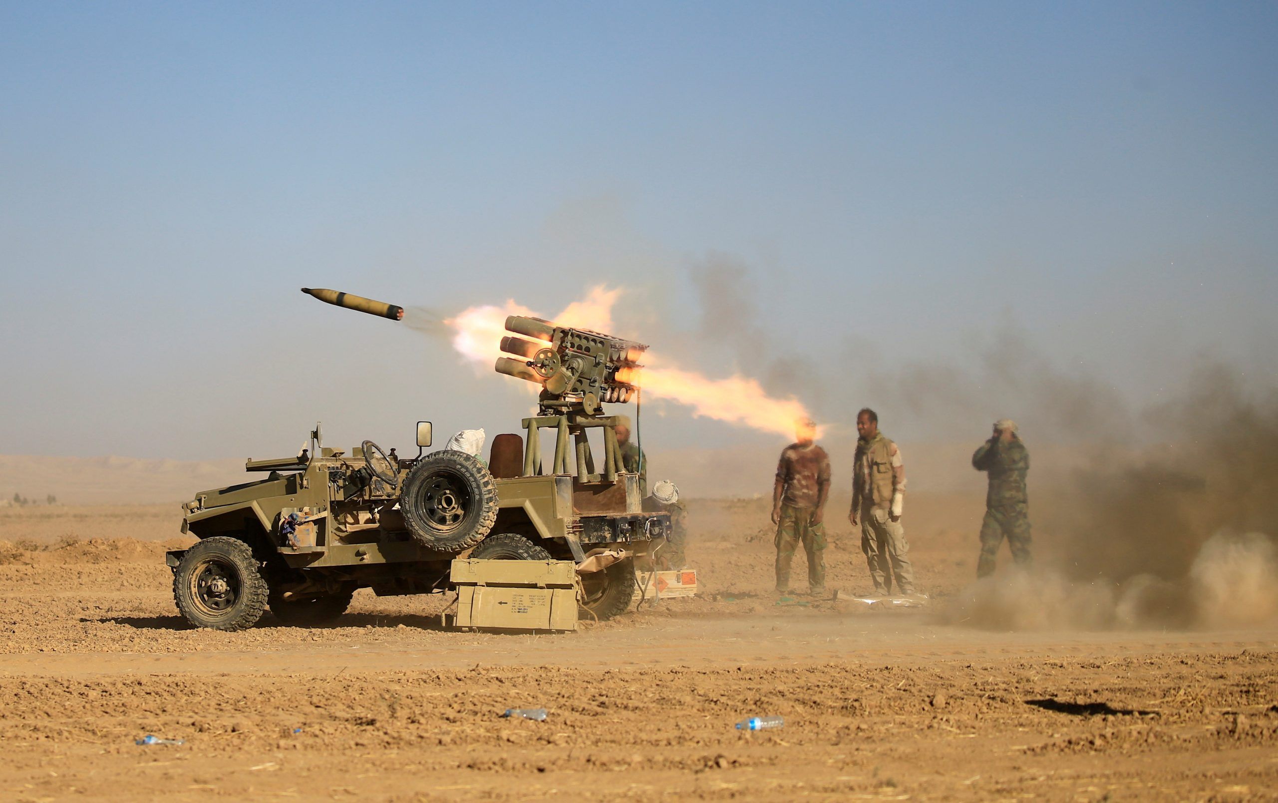 Shi'ite fighters fire a rocket towards Islamic State militants during a battle with Islamic State militants at the airport of Tal Afar, west of Mosul, Iraq, November 18, 2016. 