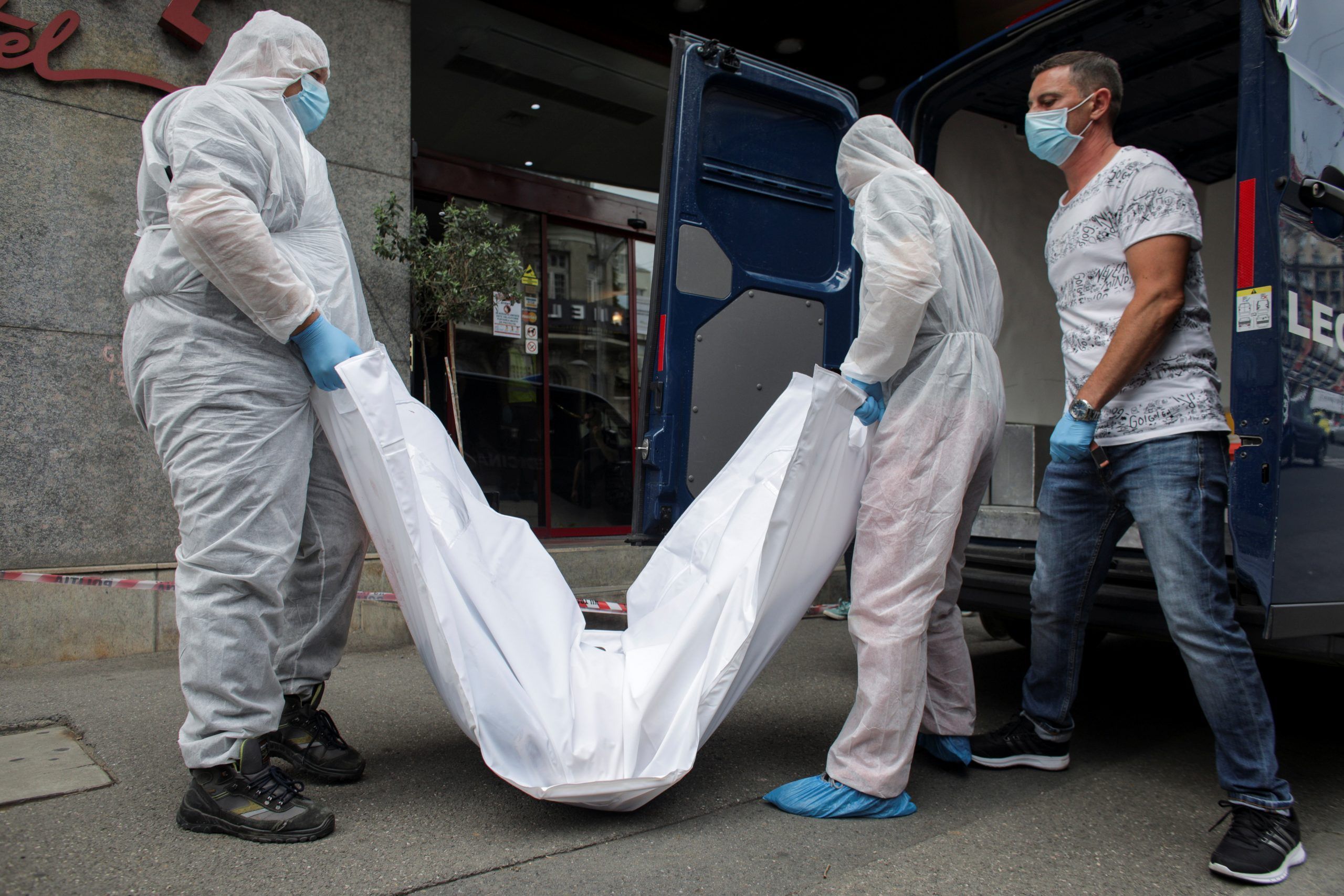 Forensic medicine staff carry a body bag, allegedly containing the remains of Gholamreza Mansouri, outside a hotel in downtown Bucharest, Romania, June 19, 2020.