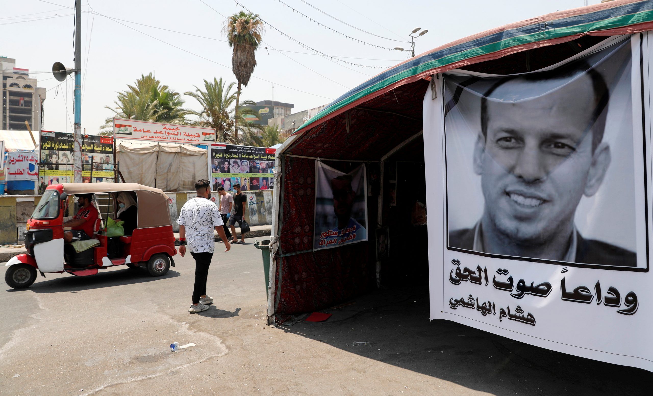 A poster depicting the former government advisor and political analyst Hisham al-Hashemi, who was killed by gunmen is seen at the Tahrir Square in Baghdad, Iraq July 8, 2020. REUTERS/Thaier al-Sudani