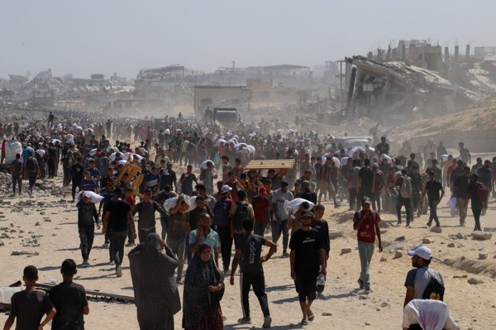 Palestinians receive aid supplies that entered Gaza through Israel, in Beit Lahia