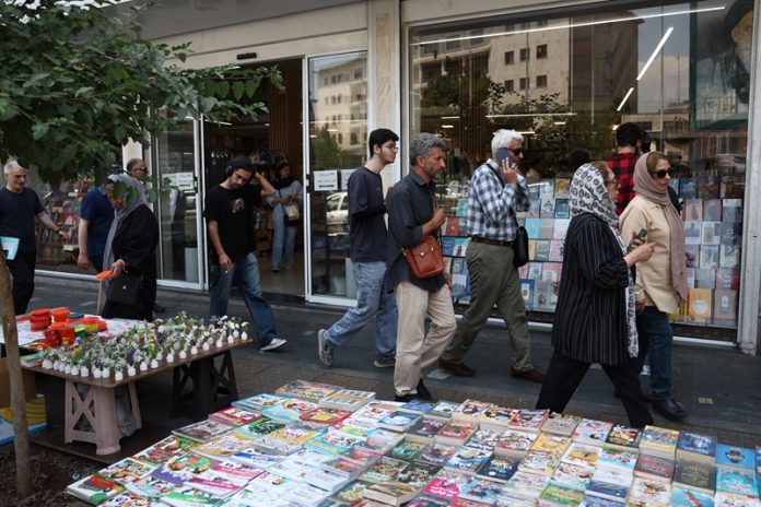 People walk on a street in Tehran