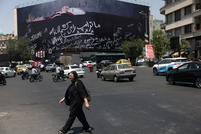 A billboard depicting U.S. President Donald Trump laid in a coffin is displayed on a building in Tehran