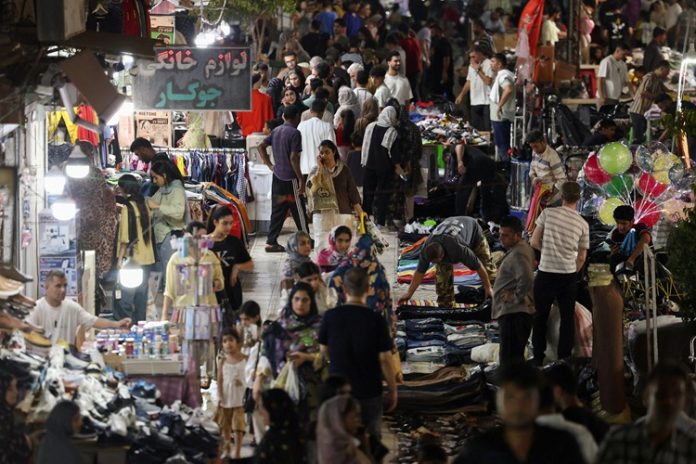 People walk in a local market in Bandar Abbas